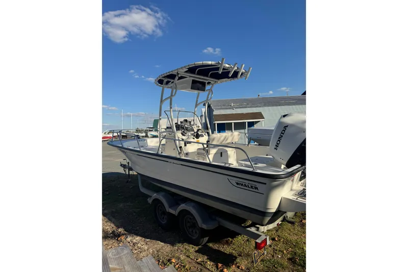 Slide: The Image of 2015 Boston Whaler 190 Montauk boat with Honda outboard motor on trailer. - 2