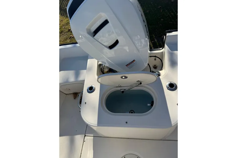Slide: The Image of 2015 Boston Whaler 190 Montauk boat with open storage compartment and engine view. - 3
