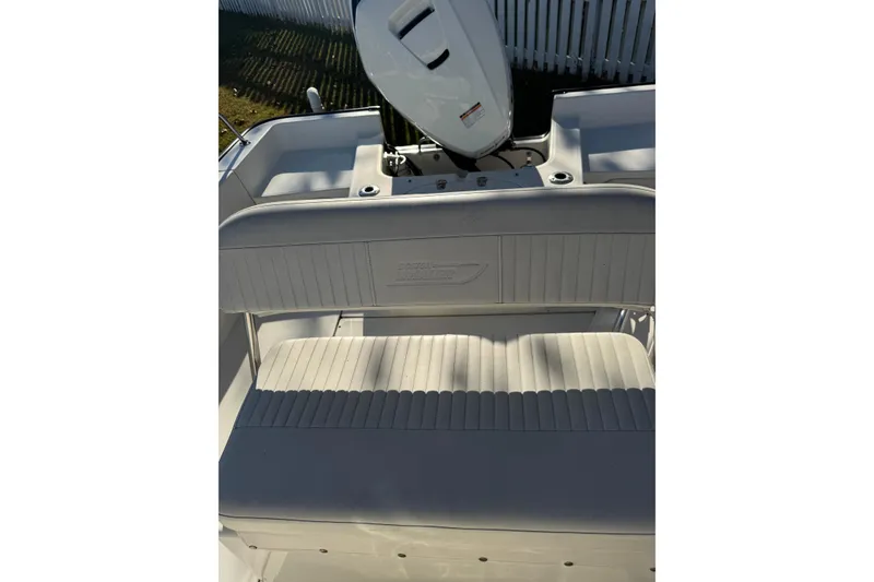 Slide: The Image of 2015 Boston Whaler 190 Montauk boat interior with seating and motor detail. - 5