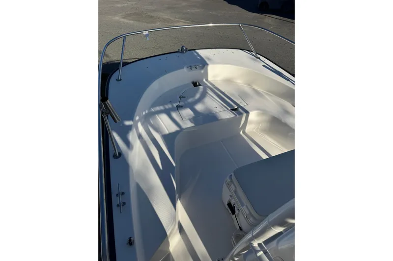 Slide: The Image of 2015 Boston Whaler 190 Montauk boat interior with seating and railings. - 6