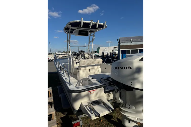 Slide: The Image of 2015 Boston Whaler 190 Montauk boat with Honda outboard motor, docked under clear sky. - 8