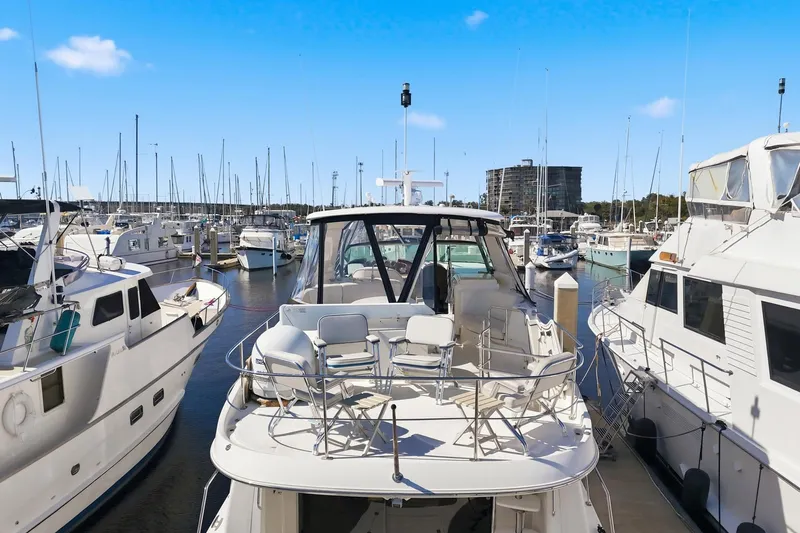 Slide: The Image of 2006 Carver 56 Voyager yacht docked in a marina, surrounded by other boats. - 10