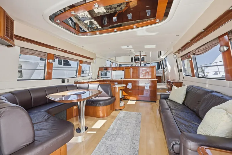 Slide: The Image of Luxurious interior of 2006 Carver 56 Voyager yacht with elegant seating and modern amenities. - 19