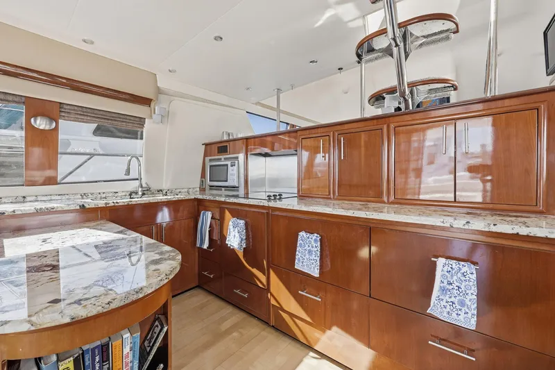 Slide: The Image of Luxurious kitchen interior of 2006 Carver 56 Voyager yacht with wood cabinetry and granite countertops. - 22