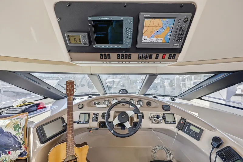 Slide: The Image of Helm of 2006 Carver 56 Voyager with navigation equipment and guitar. - 27