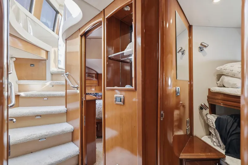 Slide: The Image of Interior of 2006 Carver 56 Voyager yacht with wooden finishes and cozy sleeping area. - 30