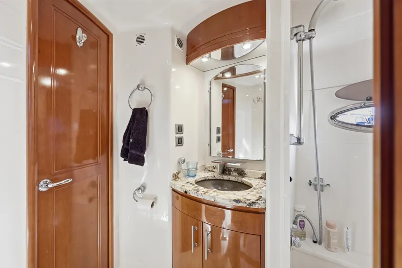Slide: The Image of Luxurious bathroom in 2006 Carver 56 Voyager yacht with granite countertop and wooden cabinetry. - 34