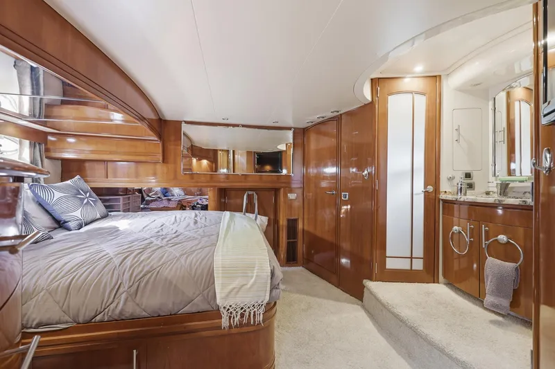 Slide: The Image of Luxurious 2006 Carver 56 Voyager yacht bedroom with elegant wood finishes and ensuite bathroom. - 35
