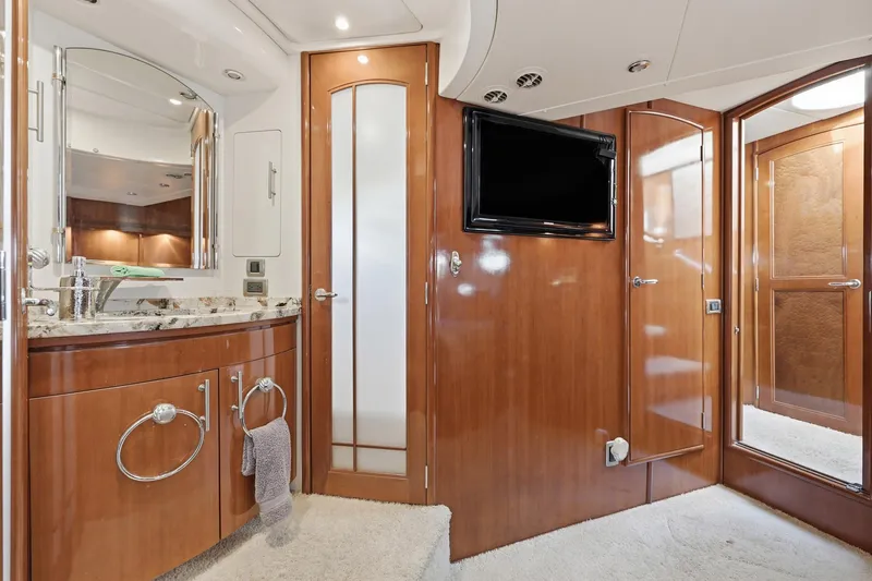 Slide: The Image of Luxurious 2006 Carver 56 Voyager yacht interior with elegant wood finishes and modern amenities. - 36