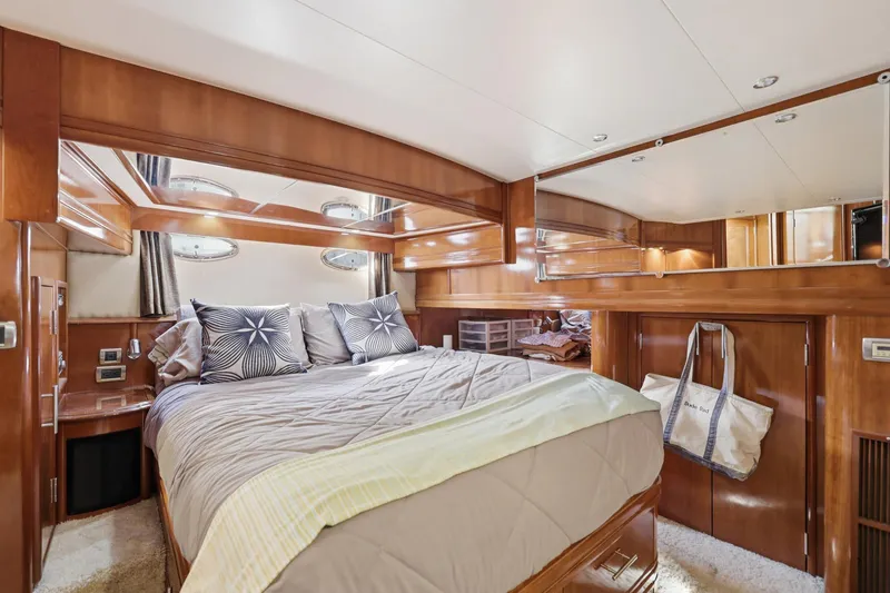 Slide: The Image of Luxurious 2006 Carver 56 Voyager yacht bedroom with elegant wood finish and plush bedding. - 37