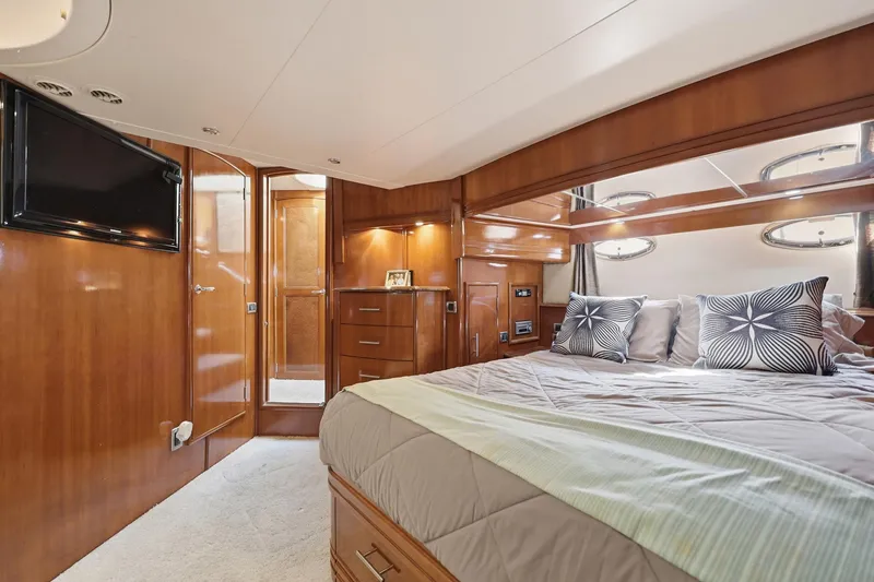 Slide: The Image of Luxurious bedroom interior of 2006 Carver 56 Voyager yacht with wood paneling and modern amenities. - 38