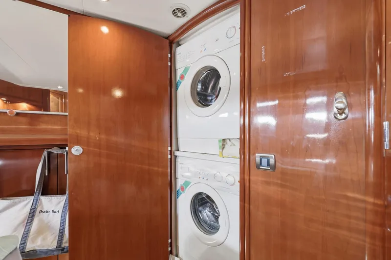 Slide: The Image of Laundry area inside 2006 Carver 56 Voyager yacht with stacked washer and dryer. - 41
