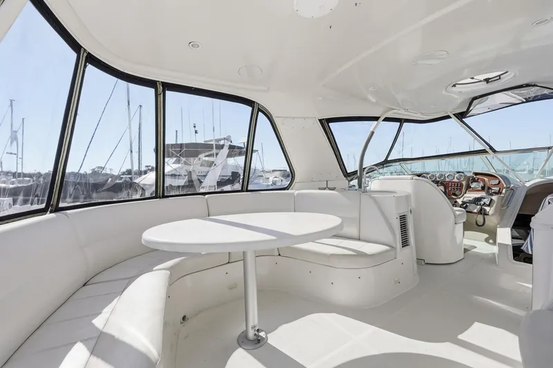 Slide: The Image of 2006 Carver 56 Voyager yacht interior with white seating and round table. - 45