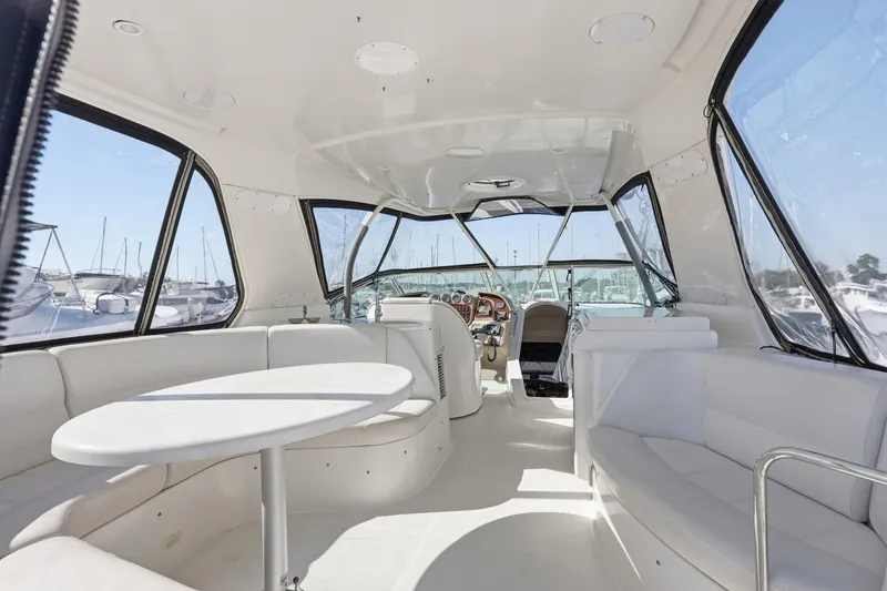 Slide: The Image of Luxurious interior of 2006 Carver 56 Voyager yacht with white seating and helm. - 46