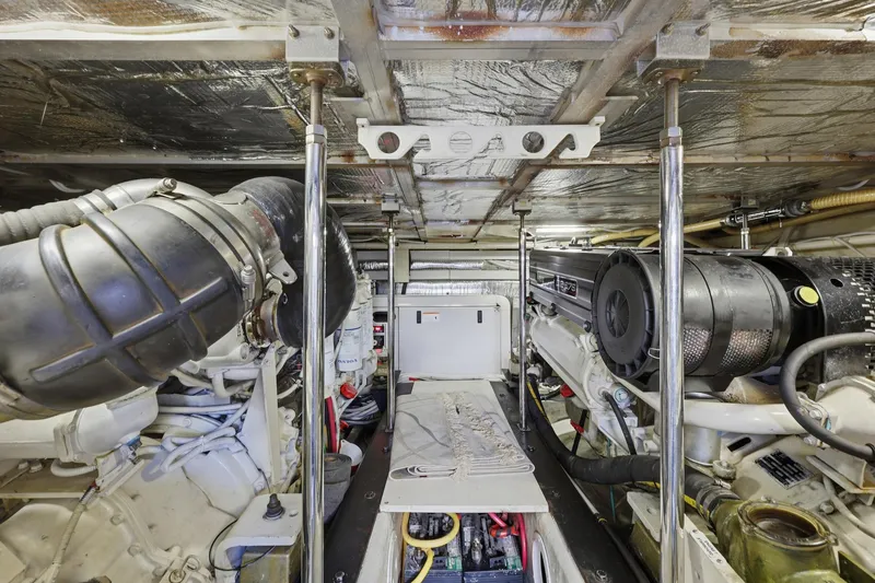 Slide: The Image of Engine room of 2006 Carver 56 Voyager yacht, showcasing mechanical components and equipment. - 53