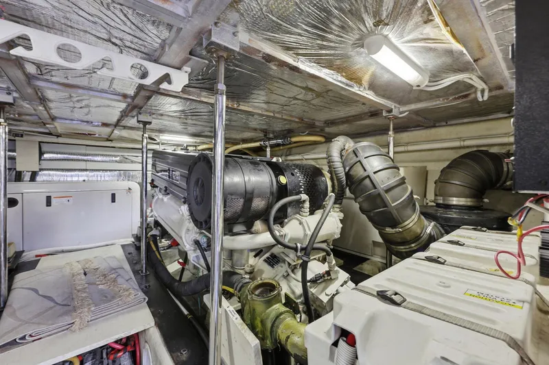 Slide: The Image of Engine room of 2006 Carver 56 Voyager yacht, showcasing mechanical components and systems. - 54