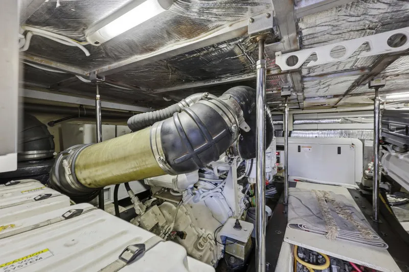 Slide: The Image of Engine room of 2006 Carver 56 Voyager yacht, showcasing mechanical components and insulation. - 55