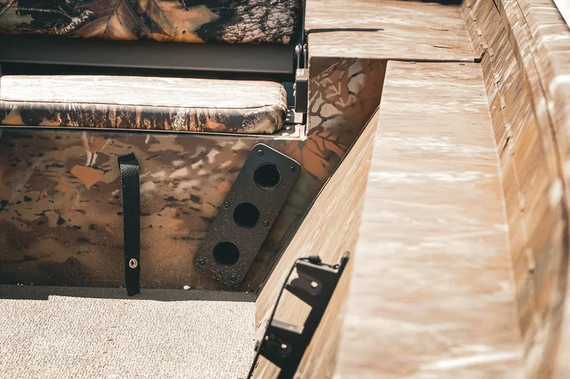 Slide: The Image of Interior of 2026 G3 Gator Tough 18 CCJ boat with camo seating and rod holders. - 17