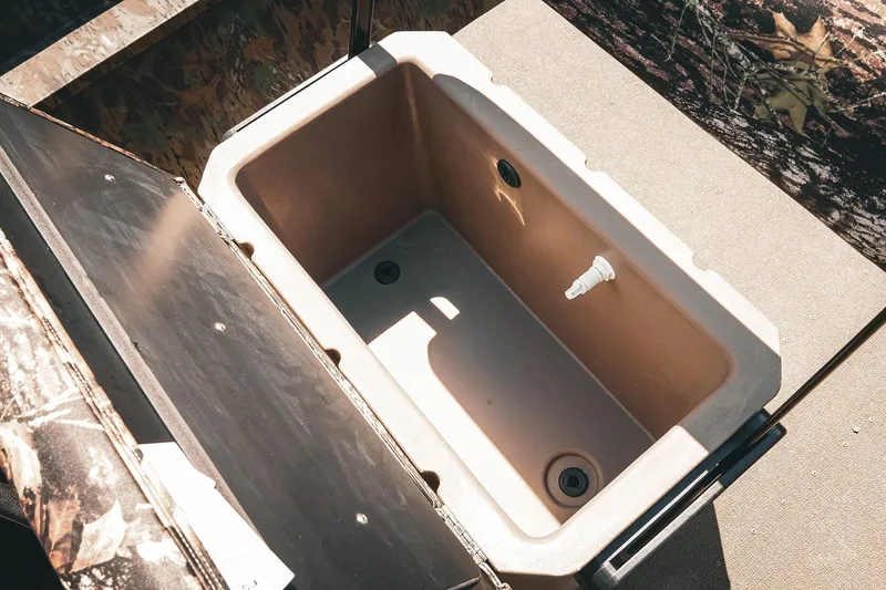 Slide: The Image of Livewell compartment in 2026 G3 Gator Tough 18 CCJ boat, featuring camouflage design. - 18