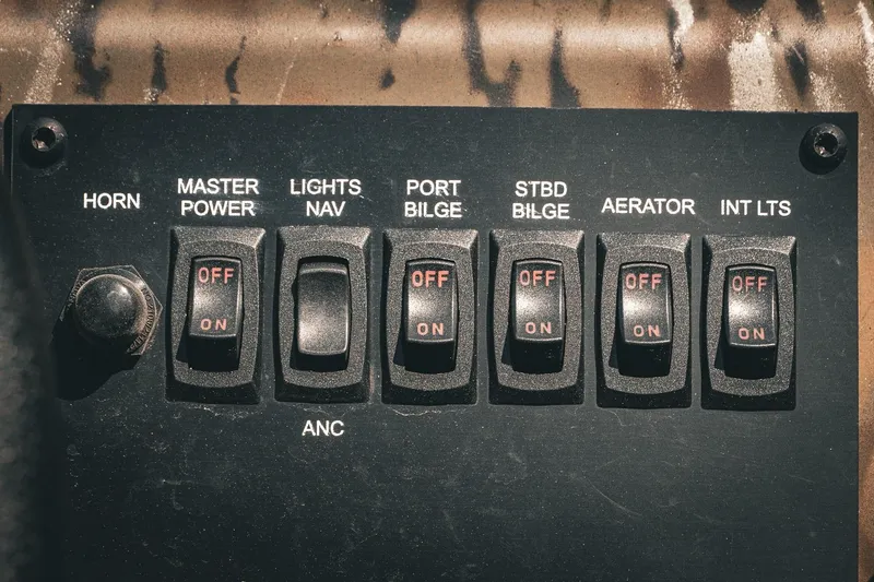 Slide: The Image of Control panel of 2026 G3 Gator Tough 18 CCJ boat with switches and labels. - 22