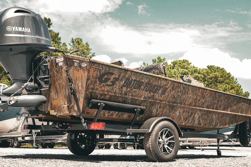 Slide: The Image of 2026 G3 Gator Tough 18 CCJ boat on trailer with Yamaha motor, outdoors. - 27
