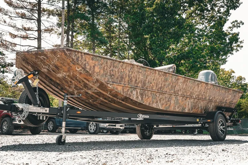 Slide: The Image of 2026 G3 Gator Tough 18 CCJ boat on trailer, camo design, parked outdoors. - 3