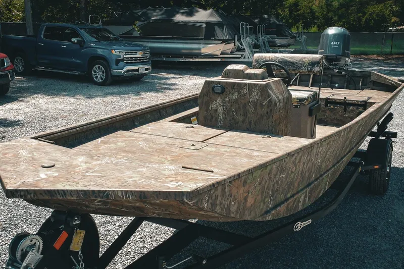 Slide: The Image of 2026 G3 Gator Tough 18 CCJ boat with camouflage design on a trailer. - 32