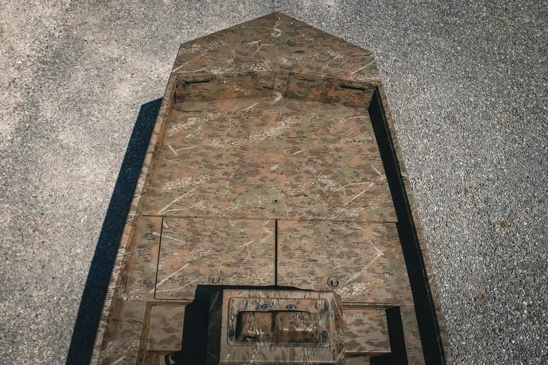 Slide: The Image of 2026 G3 Gator Tough 18 CCJ boat with camouflage design on gravel surface. - 33