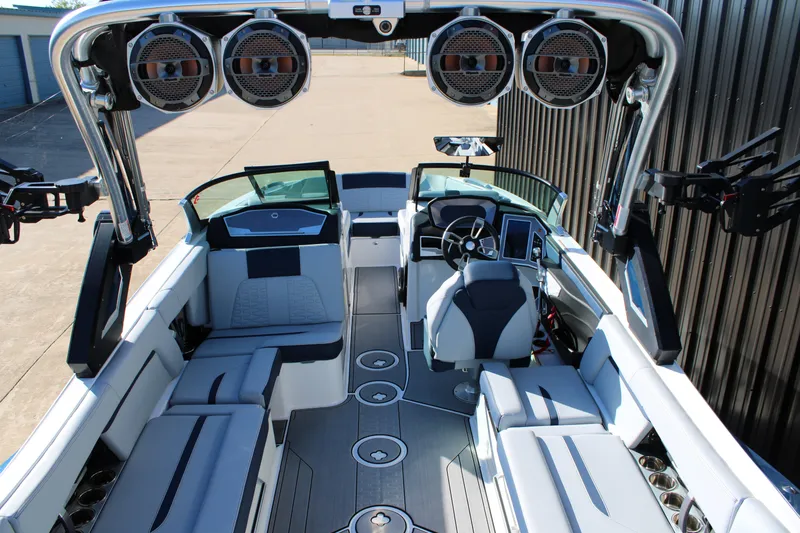 Slide: The Image of 2022 MasterCraft X24 boat interior with modern seating and advanced audio system. - 11