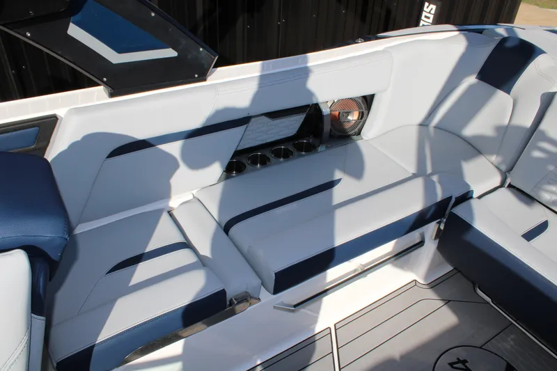 Slide: The Image of 2022 MasterCraft X24 boat interior with sleek seating and cup holders. - 14