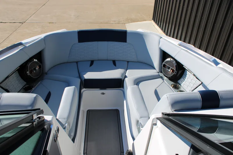 Slide: The Image of 2022 MasterCraft X24 boat interior with luxurious seating and built-in speakers. - 17
