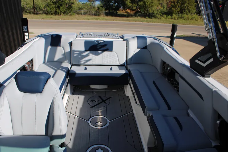 Slide: The Image of 2022 MasterCraft X24 boat interior with luxurious seating and modern design. - 18