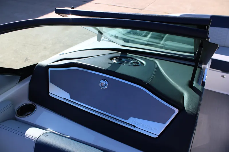 Slide: The Image of 2022 MasterCraft X24 boat dashboard with sleek design and cup holder. - 24