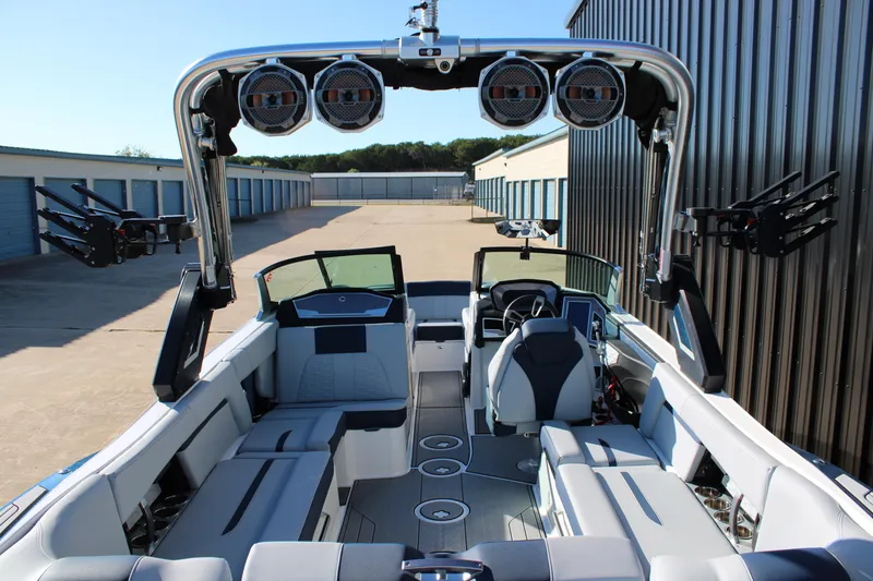 Slide: The Image of 2022 MasterCraft X24 boat interior with sleek seating and advanced audio system. - 8