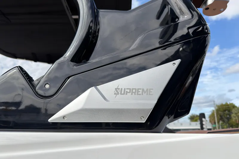 Slide: The Image of 2025 Supreme S220 boat detail with sleek black and silver design elements. - 10