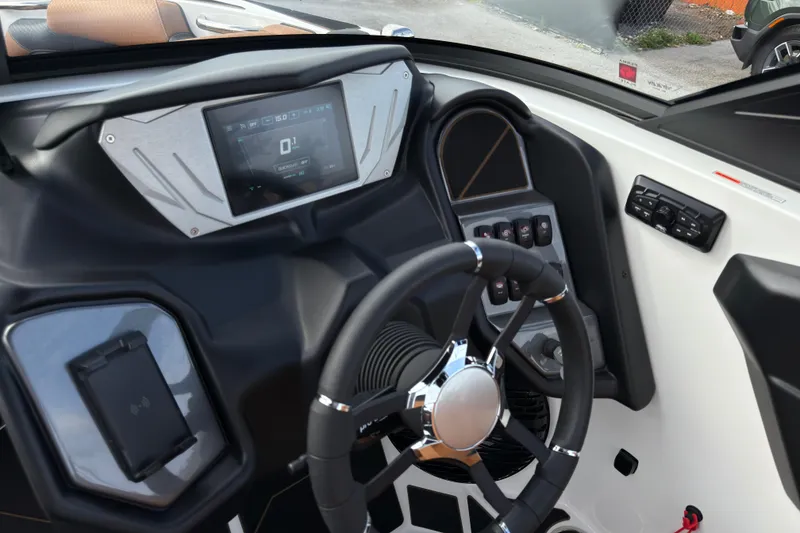 Slide: The Image of 2025 Supreme S220 boat dashboard with modern steering wheel and digital display. - 16