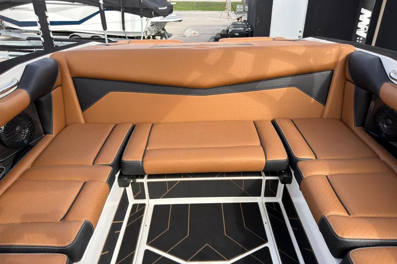 Slide: The Image of Luxurious seating in the 2025 Supreme S220 boat, featuring tan and black upholstery. - 21