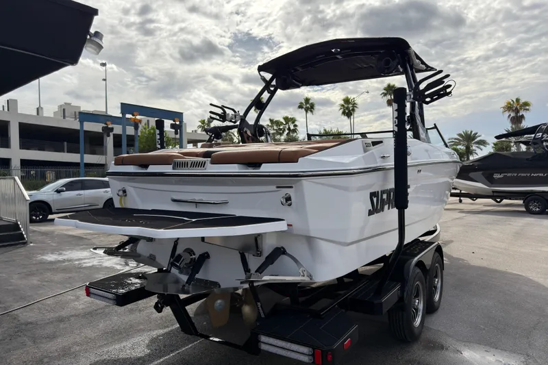 Slide: The Image of 2025 Supreme S220 boat on trailer, parked outdoors under cloudy sky. - 5