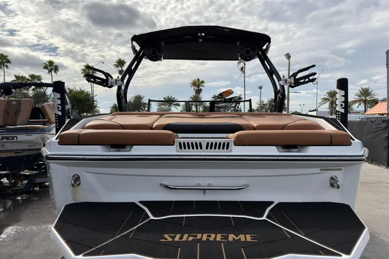 Slide: The Image of 2025 Supreme S220 boat with tan seating, sleek design, and palm trees in the background. - 6