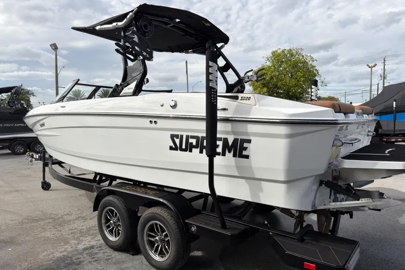 Slide: The Image of 2025 Supreme S220 boat on trailer, showcasing sleek design and modern features. - 8