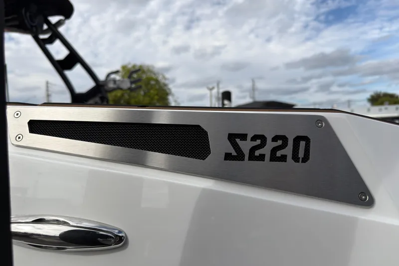 Slide: The Image of 2025 Supreme S220 boat detail with sleek metal design and logo. - 9