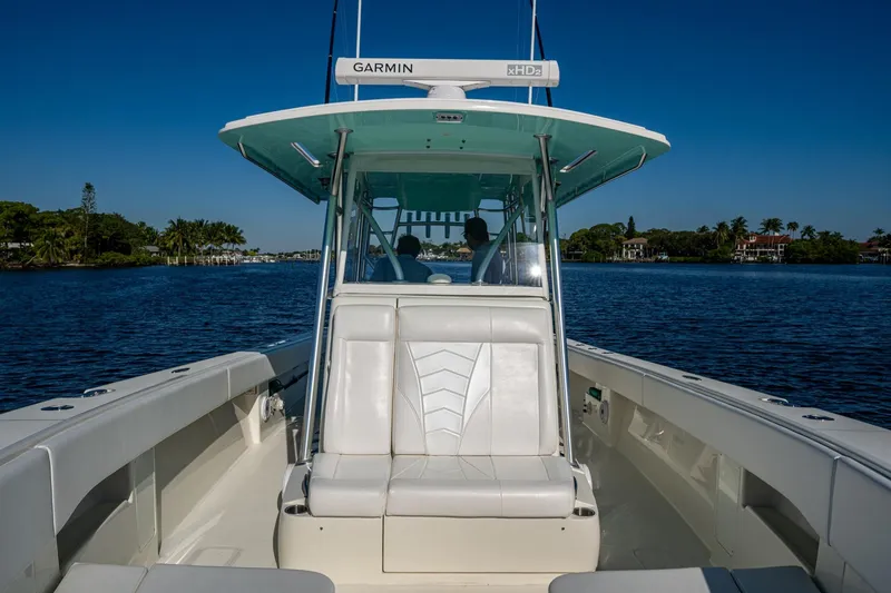 Slide: The Image of 2017 SeaVee 390Z boat on calm water, featuring Garmin equipment and sleek seating. - 10