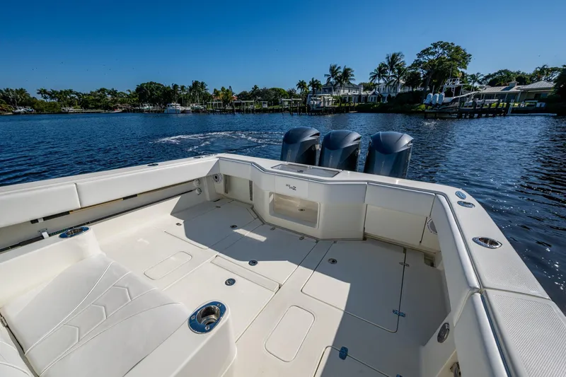 Slide: The Image of 2017 SeaVee 390Z boat with triple engines on a sunny day, dockside view. - 15