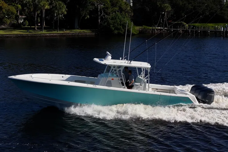 Slide: The Image of 2017 SeaVee 390Z boat cruising on a river with lush greenery in the background. - 3