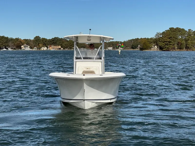 Slide: The Image of 2012 Sea Hunt Triton 240 boat on calm water, clear sky background. - 6