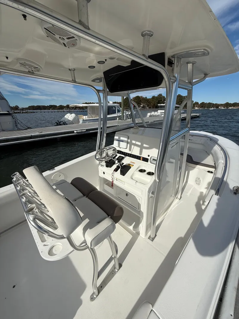 Slide: The Image of 2012 Sea Hunt Triton 240 boat interior with helm, seating, and ocean view. - 8