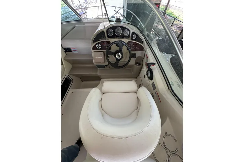 Slide: The Image of 2007 Sea Ray 260 Sundancer helm with steering wheel and control panel. - 11