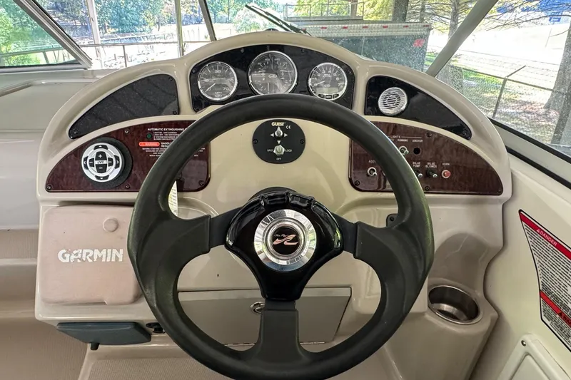 Slide: The Image of 2007 Sea Ray 260 Sundancer helm with Garmin navigation and classic instrument panel. - 12