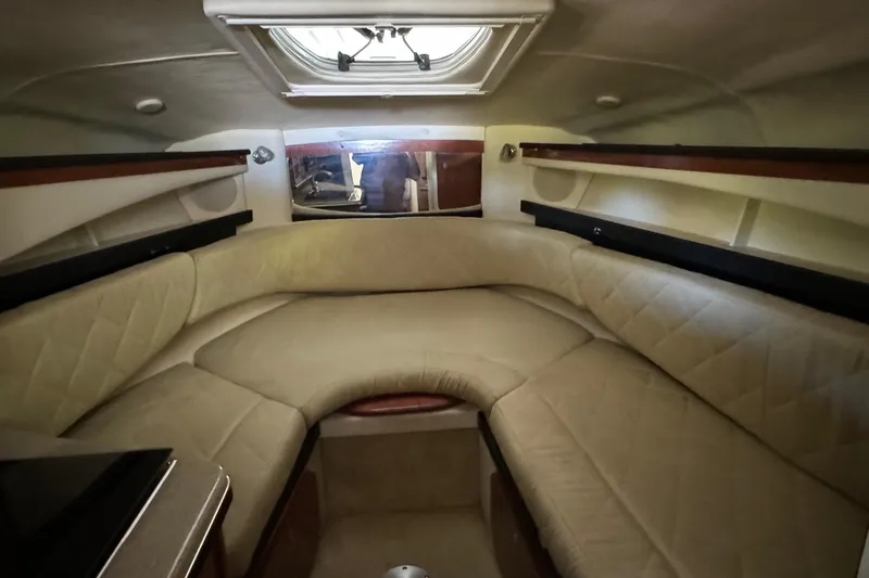 Slide: The Image of 2007 Sea Ray 260 Sundancer cabin with beige seating and overhead hatch. - 16