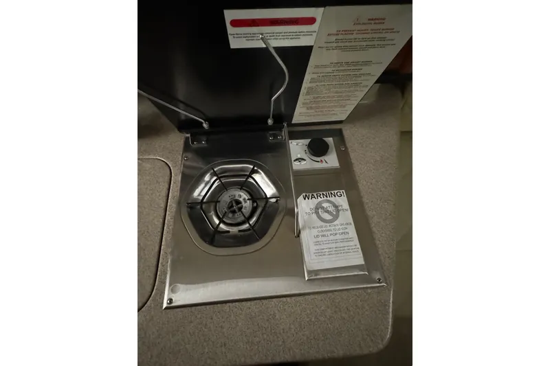 Slide: The Image of Stove on 2007 Sea Ray 260 Sundancer boat with safety warnings. - 18